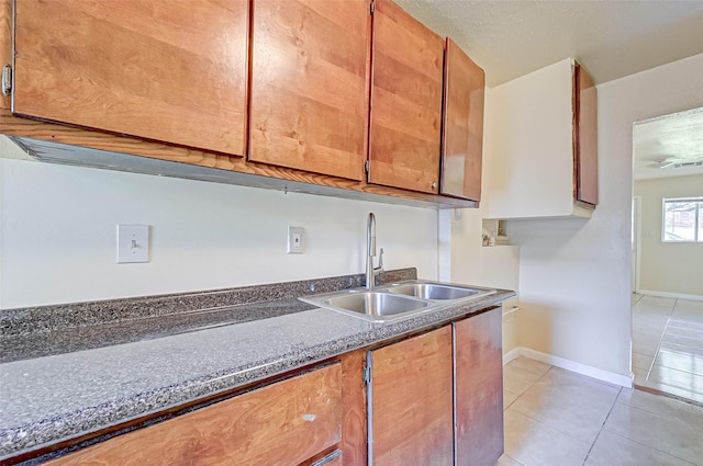 kitchen featuring sink and light tile patterned floors