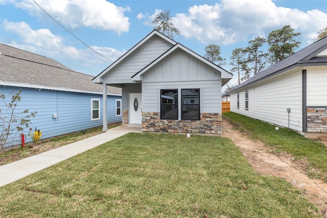 rear view of property with a lawn