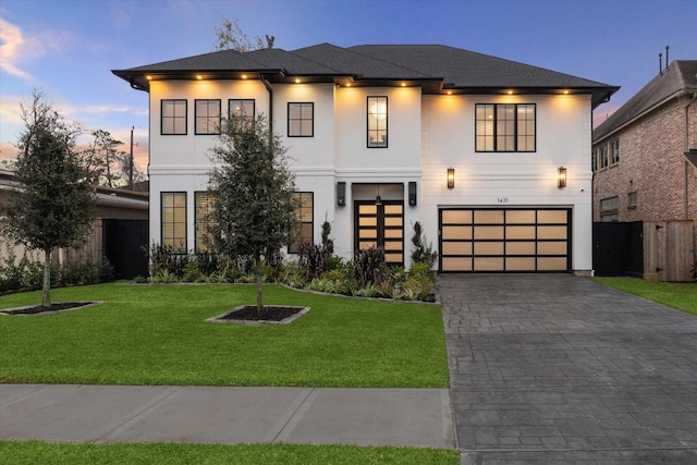 view of front of property featuring a yard and a garage