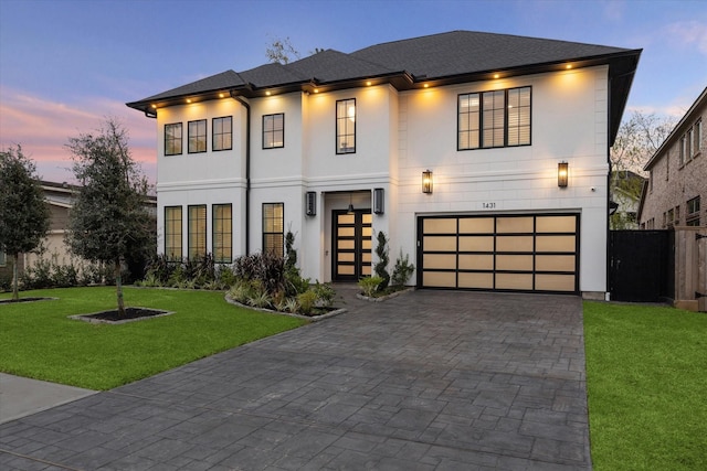 view of front of property featuring a yard and a garage