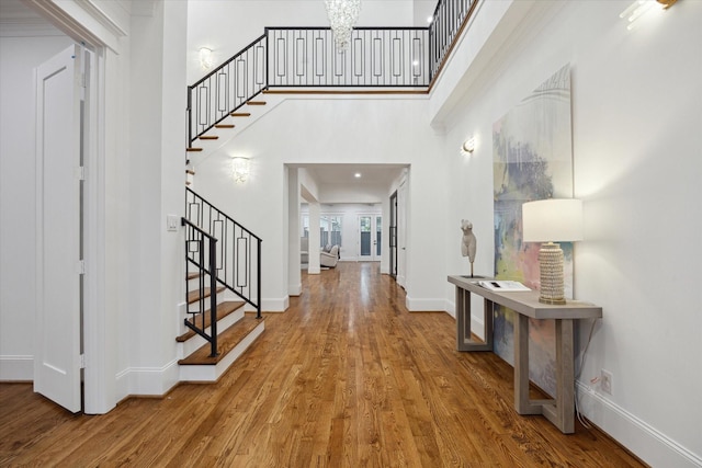 entrance foyer featuring hardwood / wood-style floors and an inviting chandelier