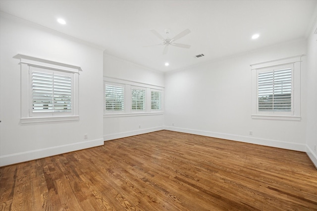 spare room featuring ceiling fan, ornamental molding, and wood-type flooring