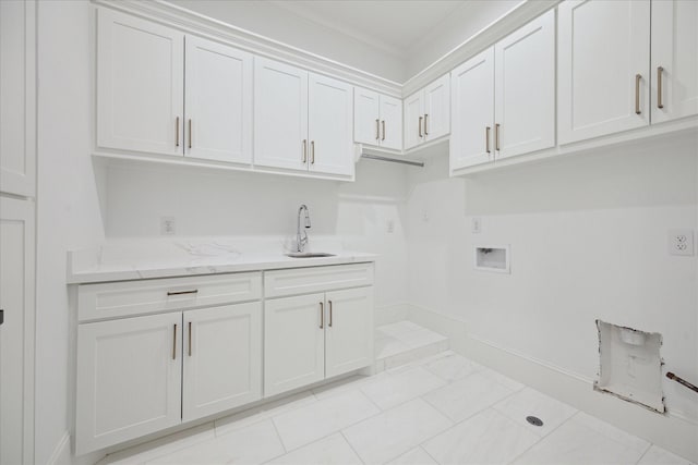 laundry room featuring cabinets, hookup for a washing machine, crown molding, sink, and light tile patterned flooring