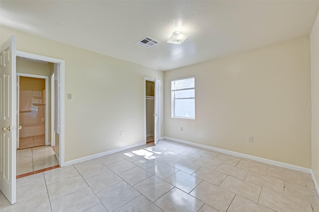 unfurnished bedroom featuring light tile patterned floors