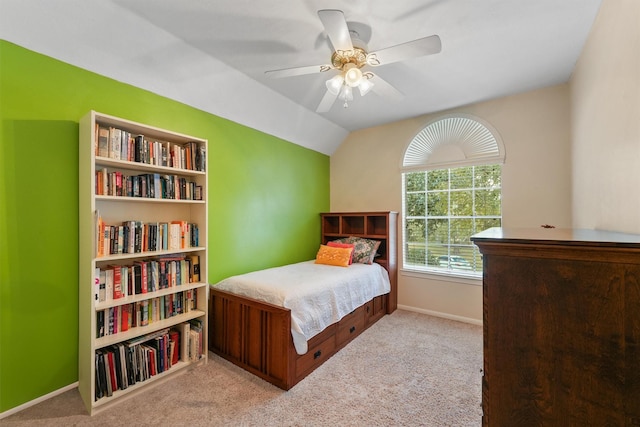 bedroom with vaulted ceiling, ceiling fan, and light carpet