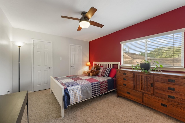 bedroom with ceiling fan and light colored carpet