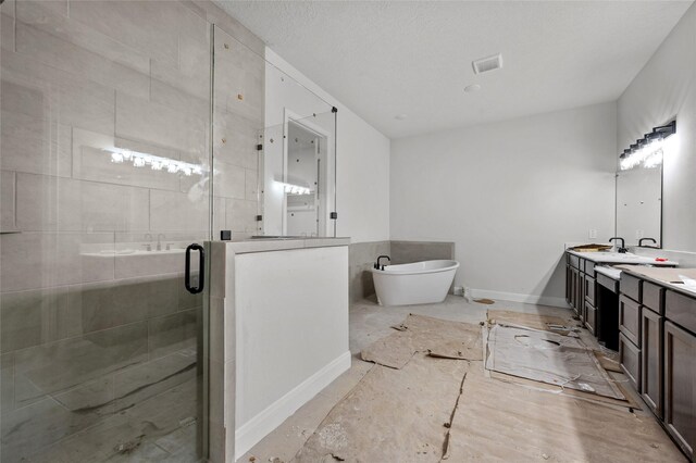 bathroom featuring vanity and independent shower and bath