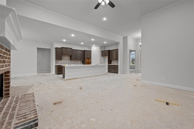 unfurnished living room with a brick fireplace, ceiling fan, and ornamental molding