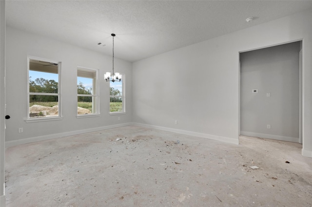 unfurnished room featuring a textured ceiling and a notable chandelier