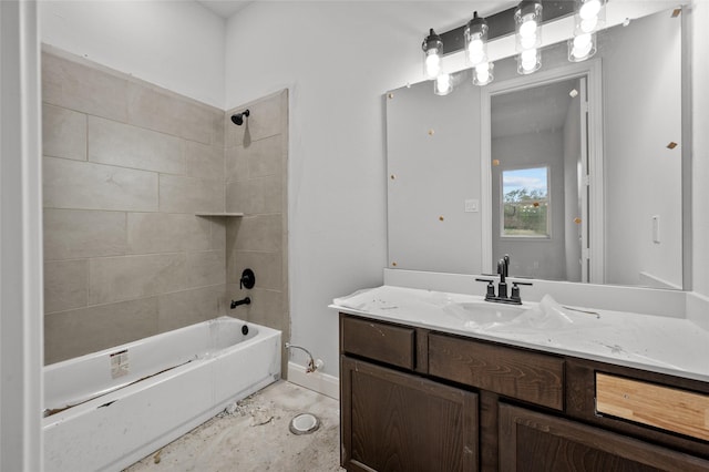 bathroom with tiled shower / bath and vanity