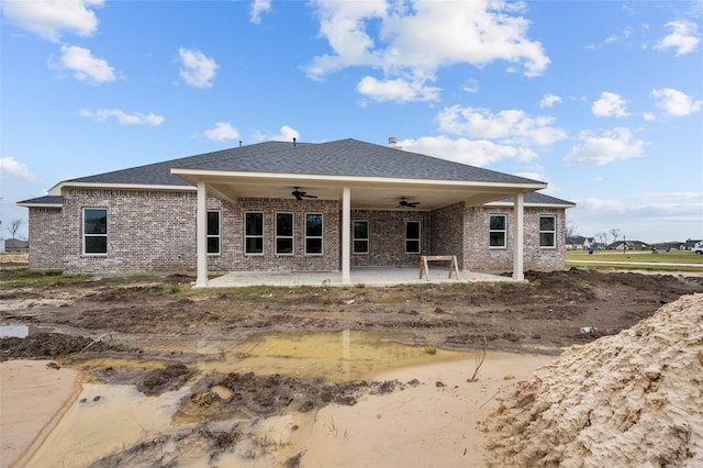 back of property with ceiling fan and a patio area