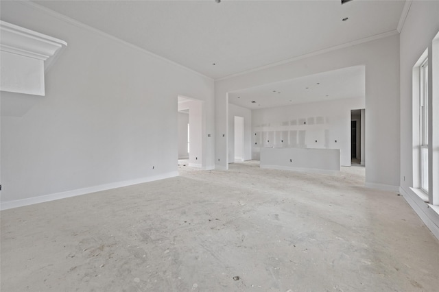 unfurnished living room featuring crown molding