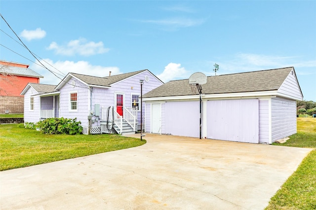 view of front of property with a garage and a front lawn