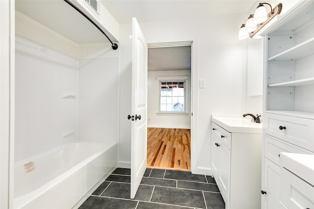 bathroom featuring tile patterned floors, vanity, and  shower combination