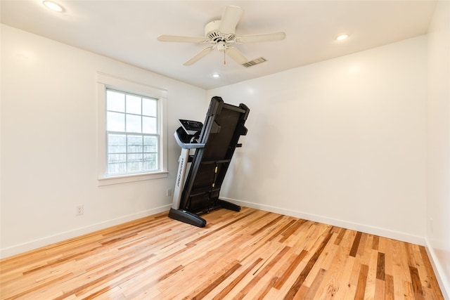 workout area featuring ceiling fan and light hardwood / wood-style flooring