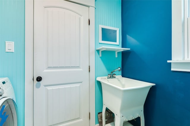 clothes washing area with sink and washer / dryer