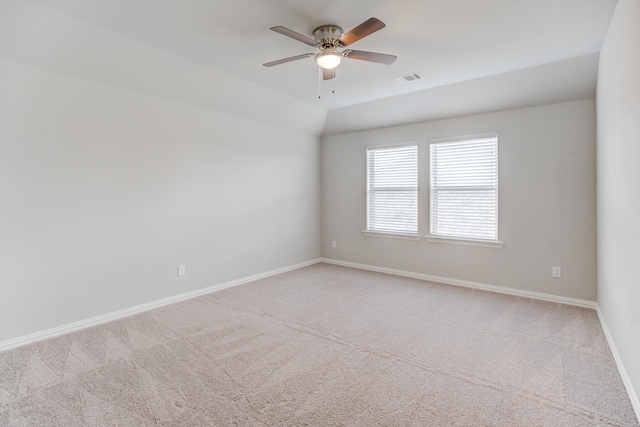 carpeted empty room featuring ceiling fan and vaulted ceiling