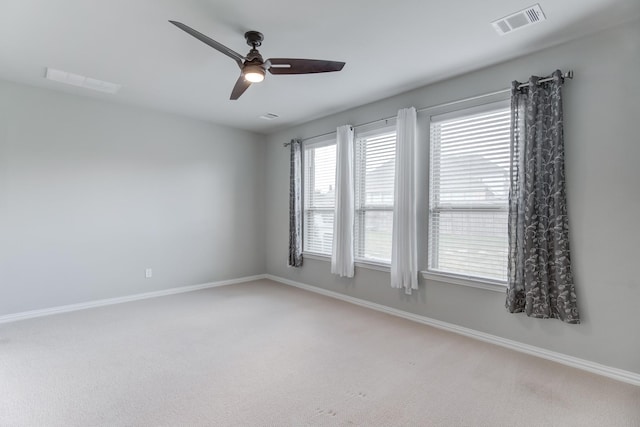 empty room with ceiling fan and carpet floors