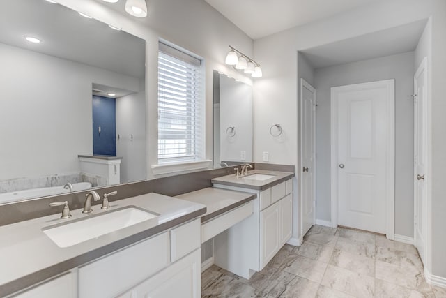 bathroom with a washtub and vanity