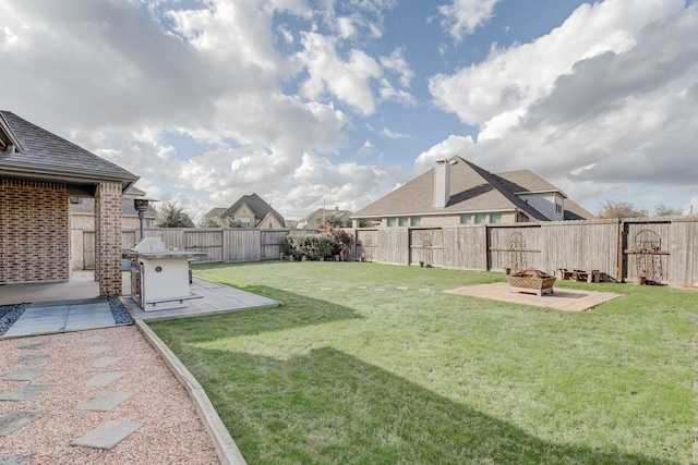 view of yard with a fire pit and a patio