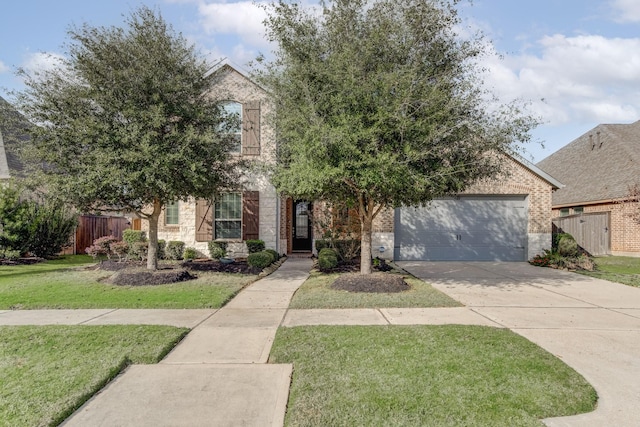 view of property hidden behind natural elements with a garage and a front yard