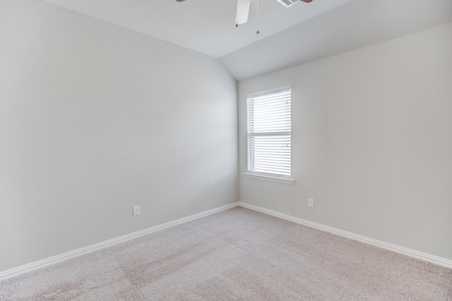 unfurnished room featuring ceiling fan, light colored carpet, and lofted ceiling