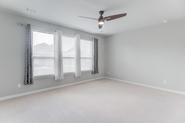 unfurnished room with ceiling fan and carpet flooring