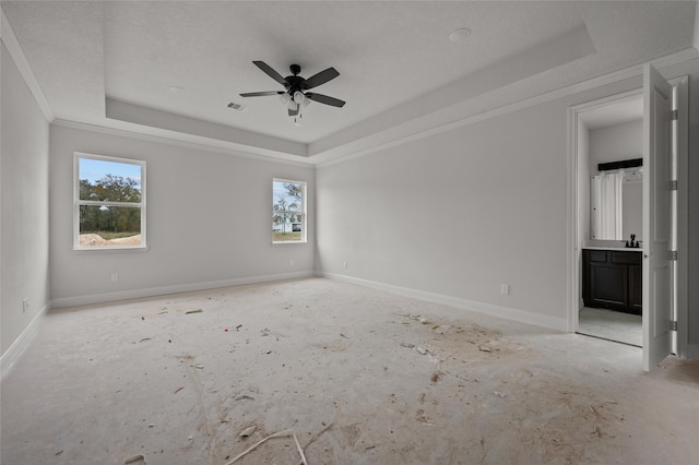 unfurnished room with ornamental molding, a raised ceiling, and ceiling fan