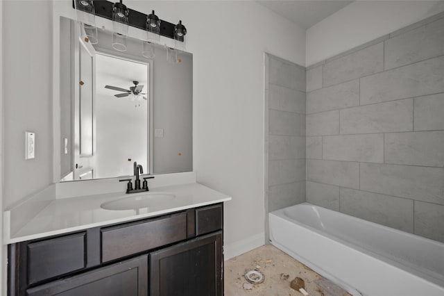 bathroom with tiled shower / bath combo, vanity, and ceiling fan