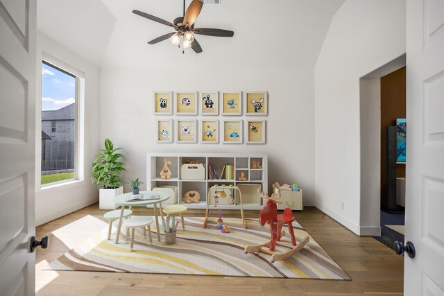 playroom with lofted ceiling, ceiling fan, and wood-type flooring