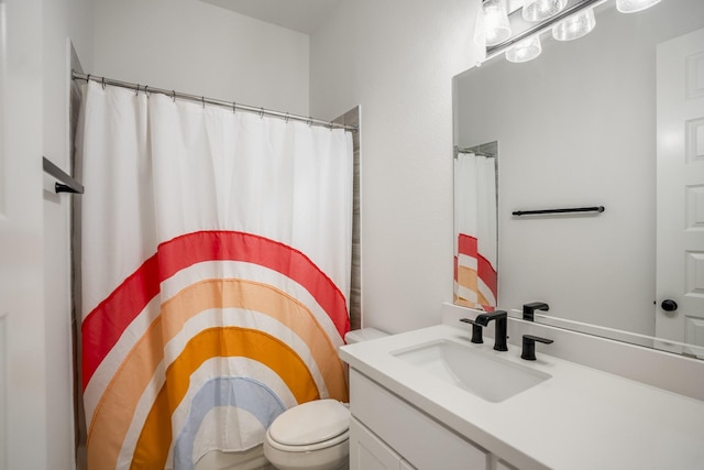 bathroom with toilet and vanity