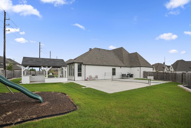 back of property with a yard, a playground, and a patio area