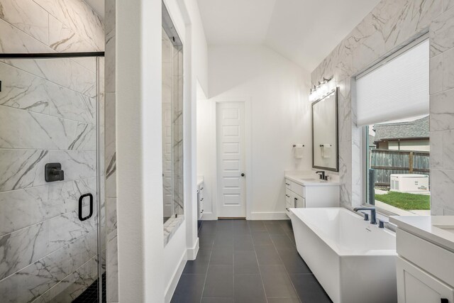 bathroom with lofted ceiling, tile patterned flooring, plus walk in shower, and vanity