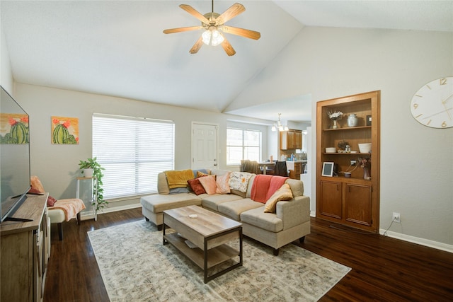 living room featuring ceiling fan with notable chandelier, high vaulted ceiling, dark hardwood / wood-style flooring, and built in shelves