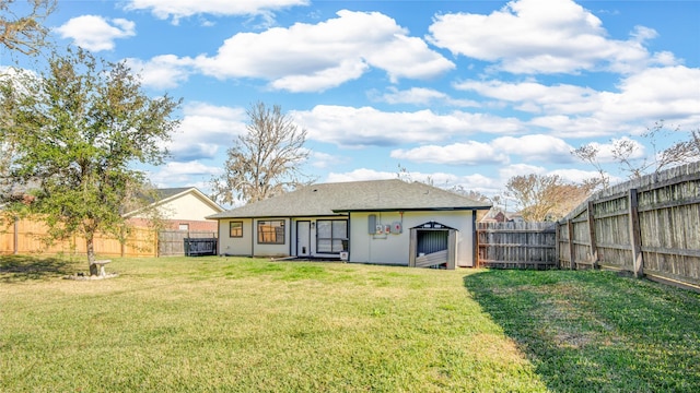 rear view of house with a lawn