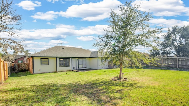 back of house featuring a yard