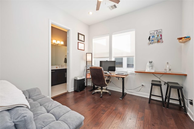 office space featuring dark wood-style floors, a ceiling fan, visible vents, and baseboards