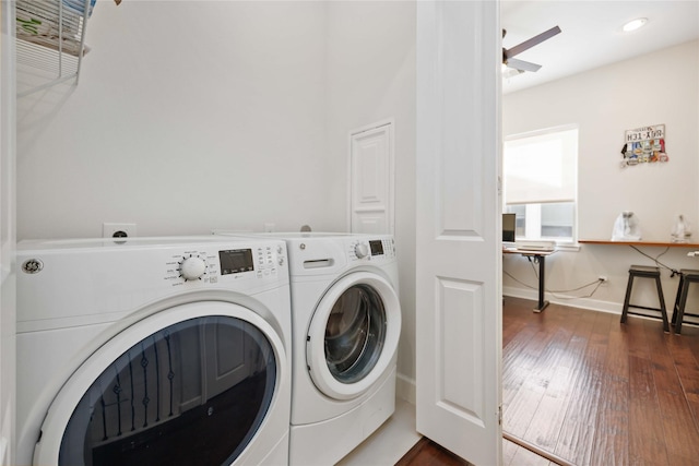 clothes washing area with dark wood-style flooring, ceiling fan, separate washer and dryer, laundry area, and baseboards