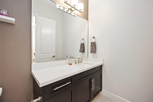 bathroom featuring tile patterned floors, baseboards, and vanity