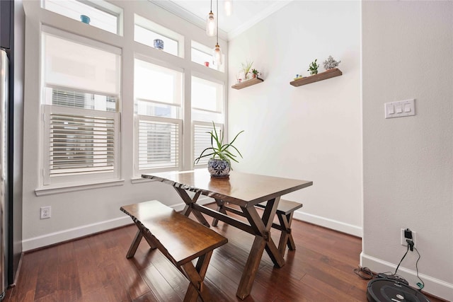 dining room with ornamental molding, dark wood finished floors, and baseboards