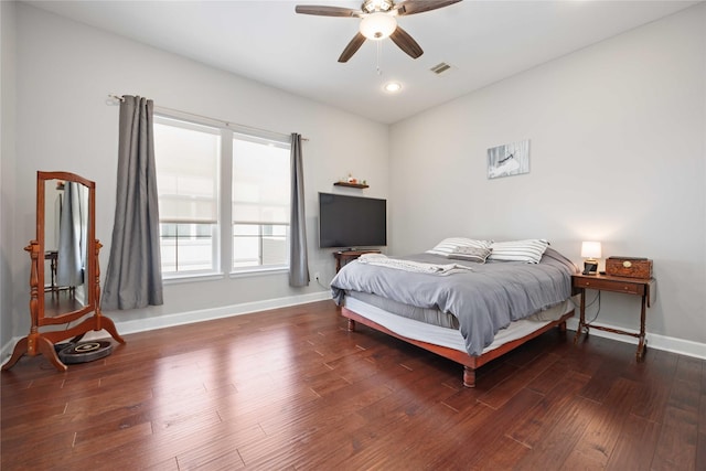 bedroom featuring dark wood-style floors, visible vents, ceiling fan, and baseboards