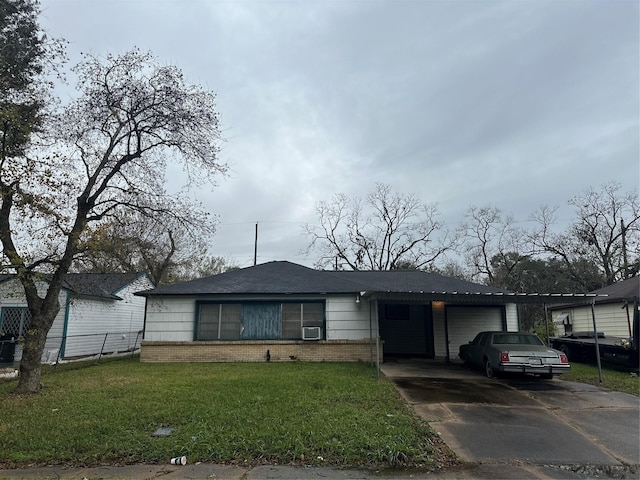 view of front facade with a front yard, a garage, and a carport