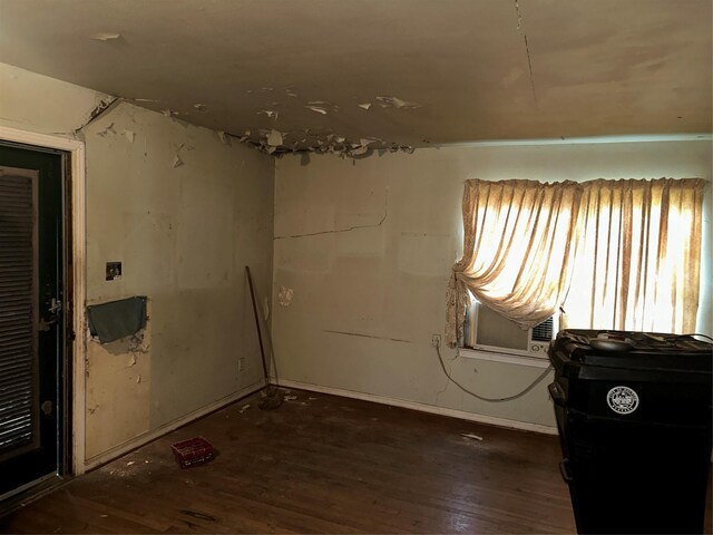 empty room featuring cooling unit and dark hardwood / wood-style flooring