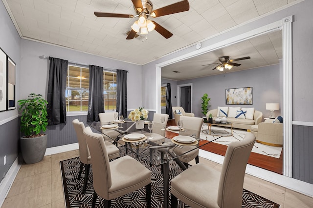 dining room with ceiling fan and crown molding