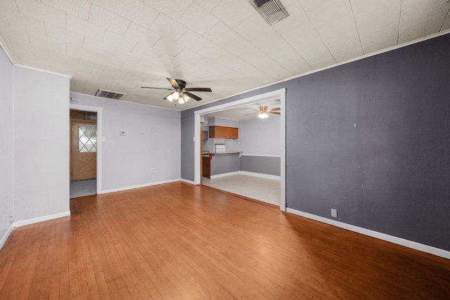 unfurnished room featuring ceiling fan, ornamental molding, and hardwood / wood-style flooring