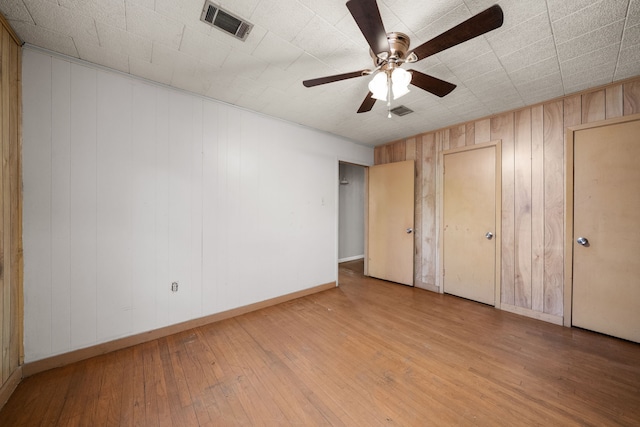 unfurnished bedroom with ceiling fan and light hardwood / wood-style flooring