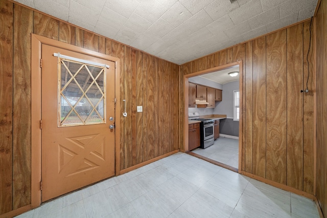 entryway featuring wooden walls