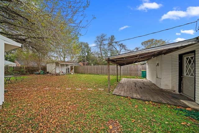 view of yard with a storage unit and a wooden deck