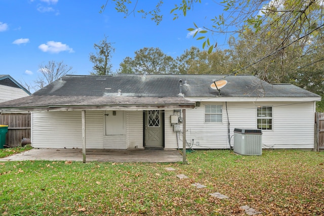 back of property featuring a lawn, a patio area, and central AC unit