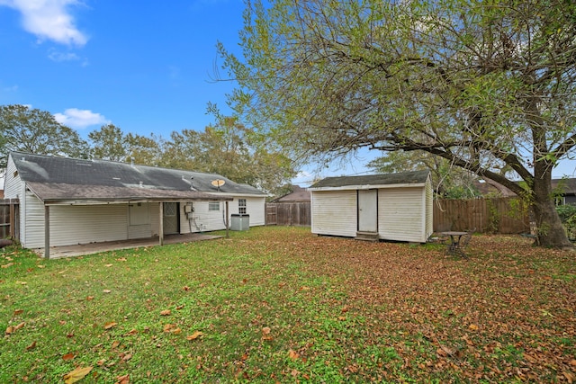 view of yard featuring a patio area and a storage shed